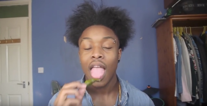 A Black man about to eat a naga chili