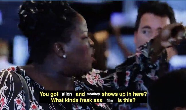 A Black woman pointing to someone off screen with the caption 'You got alien and monkey shows up in here? What kinda freak ass film is this?'